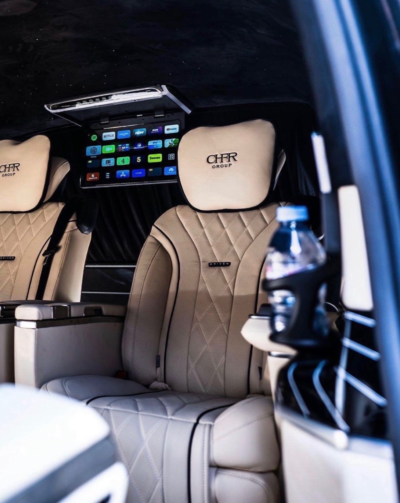 Landjet cabin with cream leather chairs and entertainment screen